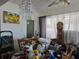 Spacious living room with vintage furniture, including clocks, lamps, and various decorative items at 915 Exmoor Way, Lake Wales, FL 33853