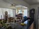 Spacious living room with vintage furniture, including clocks, lamps, and various decorative items at 915 Exmoor Way, Lake Wales, FL 33853