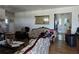 Cozy living room featuring hardwood floors, a decorative mirror, and comfortable seating arrangement at 915 Exmoor Way, Lake Wales, FL 33853