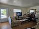 Inviting living room with hardwood floors, a decorative fireplace, and a sunlit window at 915 Exmoor Way, Lake Wales, FL 33853