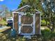 A brown wooden shed with white trim, situated in a grassy yard at 915 Exmoor Way, Lake Wales, FL 33853