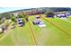 Expansive property featuring well-maintained lawn, outbuilding, and charming single-story home at 990 Brooke Rd, Fort Meade, FL 33841
