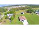 Aerial view featuring the house, outbuildings and defined property lines in a partially wooded neighborhood at 990 Brooke Rd, Fort Meade, FL 33841
