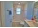 This bathroom features a bathtub and shower, a white vanity, a toilet, and a light blue wall at 990 Brooke Rd, Fort Meade, FL 33841