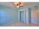 Bright bedroom with blue walls, tile flooring, and a ceiling fan at 990 Brooke Rd, Fort Meade, FL 33841