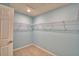Walk-in closet features ample shelving and storage space with neutral paint and tile flooring at 990 Brooke Rd, Fort Meade, FL 33841