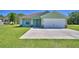 Charming one-story home with a well-manicured lawn and a spacious two-car garage at 990 Brooke Rd, Fort Meade, FL 33841