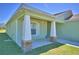 Covered porch with tiled flooring, decorative columns, and a view of the front yard at 990 Brooke Rd, Fort Meade, FL 33841