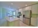 Modern kitchen with white cabinets, stainless steel appliances, and spacious island with quartz countertops at 990 Brooke Rd, Fort Meade, FL 33841