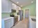Well-equipped kitchen with stainless steel appliances, white cabinetry, and ample counter space at 990 Brooke Rd, Fort Meade, FL 33841