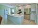 Modern kitchen featuring stainless steel appliances, quartz countertops, and tile flooring at 990 Brooke Rd, Fort Meade, FL 33841