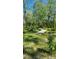 Inviting landscape featuring lush greenery, mature trees, and a bridge for a scenic and peaceful ambiance at 990 Brooke Rd, Fort Meade, FL 33841