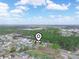 Drone shot showing property with surrounding neighborhood and lush greenery at 100 Heatherwood Blvd, Lake Wales, FL 33859
