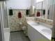 A well-lit bathroom featuring a dual vanity, shower, and toilet at 100 Heatherwood Blvd, Lake Wales, FL 33859
