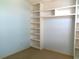 Bright bedroom features custom built-in shelving and neutral carpet at 100 Heatherwood Blvd, Lake Wales, FL 33859