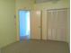 Spacious bedroom showcasing closet and doorway for easy access at 100 Heatherwood Blvd, Lake Wales, FL 33859
