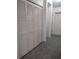 Hallway showcasing a louvered door closet with access to other rooms, with neutral tile flooring at 100 Heatherwood Blvd, Lake Wales, FL 33859