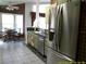 A bright kitchen space with stainless steel appliances, green cabinets, and a view to the breakfast nook at 100 Heatherwood Blvd, Lake Wales, FL 33859