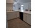 Kitchen area with white countertops, sink, cabinets and a black dishwasher beneath the counter at 100 Heatherwood Blvd, Lake Wales, FL 33859