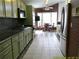 Modern kitchen featuring stainless steel appliances, tile flooring, and a view towards the dining area at 100 Heatherwood Blvd, Lake Wales, FL 33859