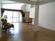 The spacious living room showcases laminate floors, a ceiling fan, and sliding doors with direct access to the lanai at 100 Heatherwood Blvd, Lake Wales, FL 33859
