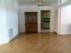 Inviting living room with laminated floors and an antique hutch cabinet adjacent to the door to the kitchen at 100 Heatherwood Blvd, Lake Wales, FL 33859
