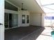 This covered patio features brick flooring and offers easy access to the home's interior through sliding glass doors at 100 Heatherwood Blvd, Lake Wales, FL 33859