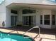 Covered outdoor patio with brick flooring, ceiling fan, sliding glass doors, and direct access to the pool at 100 Heatherwood Blvd, Lake Wales, FL 33859