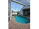 This inviting pool features a screen enclosure and well-maintained landscaping at 100 Heatherwood Blvd, Lake Wales, FL 33859