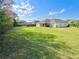 Expansive backyard features lush green grass and plenty of room for outdoor activities and recreation at 1055 Lena Run Ct, Winter Haven, FL 33880