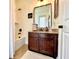 Bathroom featuring updated vanity, large mirror, and shower-tub combination at 1055 Lena Run Ct, Winter Haven, FL 33880