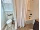 Bathroom featuring a shower-tub combination, toilet and neutral tile flooring at 1055 Lena Run Ct, Winter Haven, FL 33880