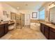 Bright bathroom featuring a glass shower, soaking tub, granite countertops, and stylish decor at 1055 Lena Run Ct, Winter Haven, FL 33880