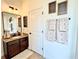 Bathroom featuring updated vanity, large mirror, and decorative accents at 1055 Lena Run Ct, Winter Haven, FL 33880