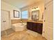 Bathroom showcasing a soaking tub, granite countertop vanity, and tiled accents at 1055 Lena Run Ct, Winter Haven, FL 33880