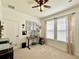 Bright bedroom featuring neutral carpet, ceiling fan, and two windows with natural light at 1055 Lena Run Ct, Winter Haven, FL 33880