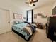 Bright bedroom featuring neutral walls, a ceiling fan, and a cozy bed adorned with fun shark-themed bedding at 1055 Lena Run Ct, Winter Haven, FL 33880