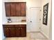Convenient butlers pantry featuring cabinets and counter space at 1055 Lena Run Ct, Winter Haven, FL 33880