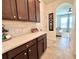 Convenient butlers pantry, with hallway access, featuring cabinets and counter space at 1055 Lena Run Ct, Winter Haven, FL 33880