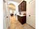 Convenient butlers pantry with hallway access featuring cabinets and counter space at 1055 Lena Run Ct, Winter Haven, FL 33880