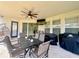 Covered patio includes dining table and outdoor grill, perfect for entertaining guests and enjoying the outdoors at 1055 Lena Run Ct, Winter Haven, FL 33880
