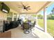 Relaxing covered patio with ceiling fan and outdoor kitchen perfect for dining and entertaining guests at 1055 Lena Run Ct, Winter Haven, FL 33880