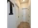Hallway with neutral walls, tile flooring, and multiple doors at 1055 Lena Run Ct, Winter Haven, FL 33880