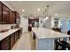 Kitchen featuring a large island with a sink, stainless steel appliances, and cabinetry at 1055 Lena Run Ct, Winter Haven, FL 33880
