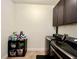 Well-equipped laundry area with modern appliances, upper cabinets, and shelf with cleaning supplies at 1055 Lena Run Ct, Winter Haven, FL 33880