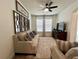 Inviting living room with neutral-toned sofas, stylish curtains, and sleek entertainment center at 1055 Lena Run Ct, Winter Haven, FL 33880