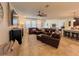 Open-concept living area features modern decor, spacious layout, and comfortable leather seating at 1055 Lena Run Ct, Winter Haven, FL 33880