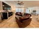 Expansive living room with large TV, leather seating, and an open view to the dining area at 1055 Lena Run Ct, Winter Haven, FL 33880
