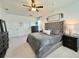 Spacious main bedroom featuring carpet flooring, neutral colors, and large windows at 1055 Lena Run Ct, Winter Haven, FL 33880