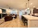 Bright, open-concept living space features a modern kitchen island and comfortable living area at 1055 Lena Run Ct, Winter Haven, FL 33880